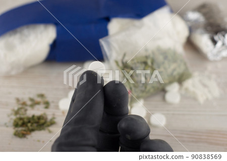 cocaine, heroin, spice, marijuana and etc - lots of unknown pills, white powder in a transparent package and the foil and similar to the "spice" mixture, hand in a black glove holding a single pill cocaine, heroin, spice, marijuana and etc - lots of unknown pills, white powder in a transparent package and the foil and similar to the "spice" mixture, hand in a black glove holding a single pill 90838569