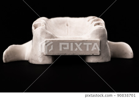 Upper human jaw without teeth model medical implant isolated on black background. Healthy teeth, dental care and orthodontic concept. Upper human jaw without teeth model medical implant isolated on black background. Healthy teeth, dental care and orthodontic concept. 90838701