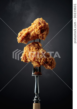 Fried chicken on a fork. 90839601