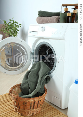 Concept of housework with washing machine against white wall 90839833