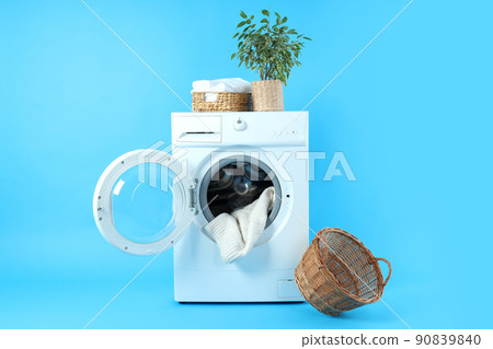 Concept of housework with washing machine on blue background Concept of housework with washing machine on blue background 90839840