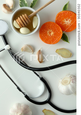 Concept of treatment colds with honey and garlic on white background 90840302