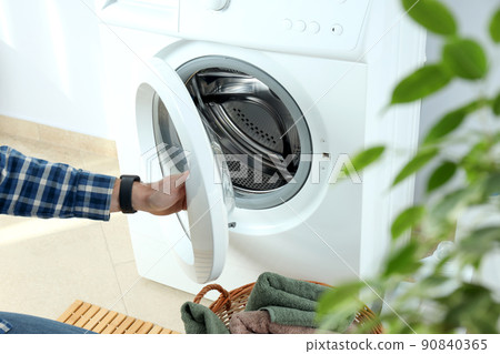 Concept of housework with washing machine against white wall Concept of housework with washing machine against white wall 90840365