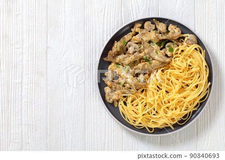 liver stroganoff with spaghetti on plate, top view liver stroganoff with spaghetti on plate, top view 90840693
