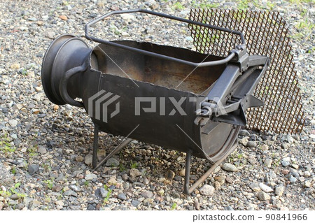 A barbecue stove made from a milk can and a car jack A barbecue stove made from a milk can and a car jack 90841966