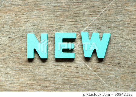Color alphabet letter in word new on wood background Color alphabet letter in word new on wood background 90842152