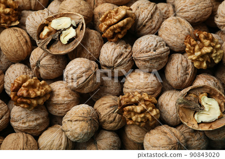 Walnuts with nutshell all over background, top view Walnuts with nutshell all over background, top view 90843020