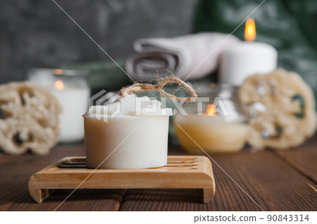 Natural soap, loofah scrubber on podium in bathroom. Zero waste in life. Relaxation spa concept, candles, beauty... Natural soap, loofah scrubber on podium in bathroom. Zero waste in life. Relaxation spa concept, candles, beauty... 90843314