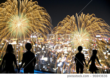 Silhouette and night view of a couple staring at fireworks 90843636