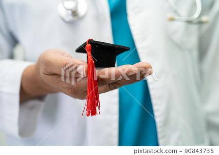 Asian doctor study learn with graduation gap hat in hospital ward, clever bright genius education medicine concept. Asian doctor study learn with graduation gap hat in hospital ward, clever bright genius education medicine concept. 90843738