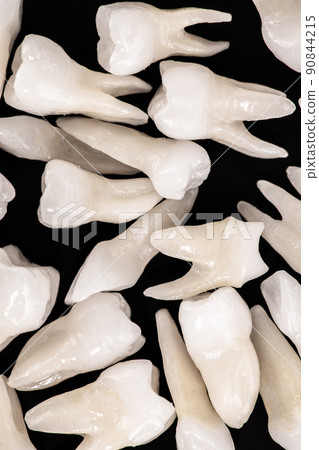 Prosthetic dentistry White teeth on black background Oral dental hygiene Dental health concept Oral care teeth restoration top view. Prosthetic dentistry White teeth on black background Oral dental hygiene Dental health concept Oral care teeth restoration top view. 90844215