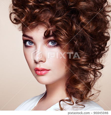 Brunette woman with curly and shiny hair 90845046
