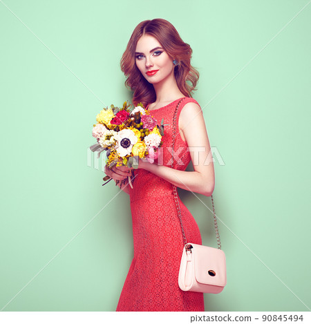Blonde young woman in elegant red dress Blonde young woman in elegant red dress 90845494