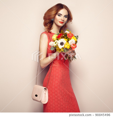 Blonde young woman in elegant red dress Blonde young woman in elegant red dress 90845496