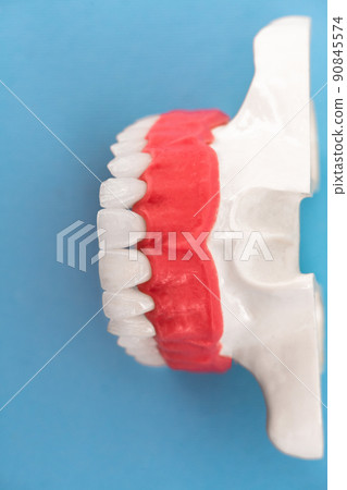 Teeth implant and crown installation process parts isolated on a blue background. Medically accurate 3D model.  90845574