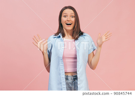 Excited young beautiful girl wearing top and summer shirt looking at camera isolated on pink background. Concept of emotions, facial expression, youth 90845744