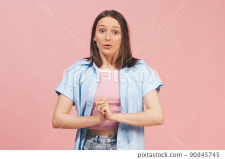 Young surprised girl wearing top and summer shirt looking at camera isolated on pink background. Concept of emotions, facial expression, youth Young surprised girl wearing top and summer shirt looking at camera isolated on pink background. Concept of emotions, facial expression, youth 90845745