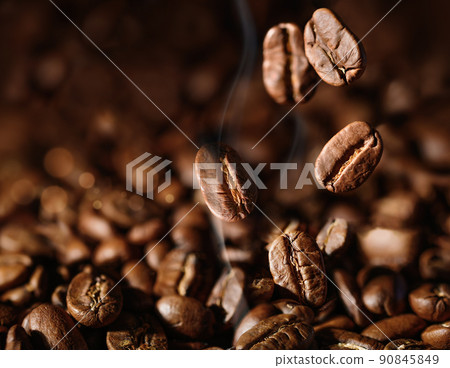 Brown Roasted Coffee beans closeup on dark Background 90845849
