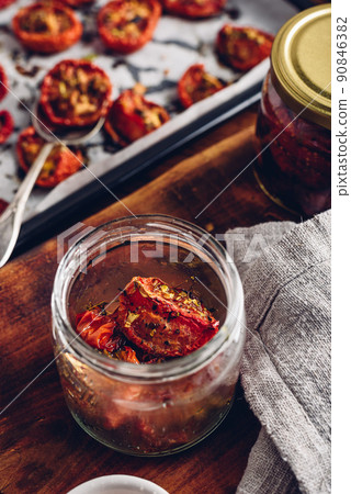 Prepared Sun Dried Tomatoes with Oil and Herbs in a Jar Prepared Sun Dried Tomatoes with Oil and Herbs in a Jar 90846382