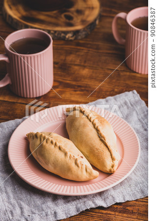 Two Cabbage Hand Pies on Plate 90846387