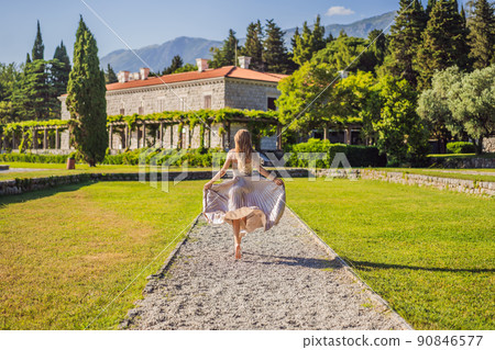 Woman tourist walking in Montenegro. Panoramic summer landscape of the beautiful green Royal park Milocer on the shore of the the Adriatic Sea, Montenegro Woman tourist walking in Montenegro. Panoramic summer landscape of the beautiful green Royal park Milocer on the shore of the the Adriatic Sea, Montenegro 90846577