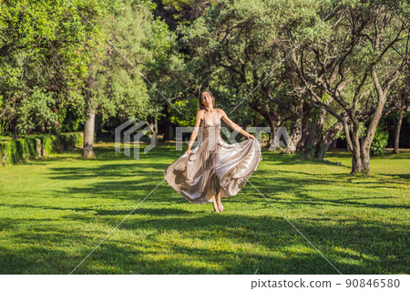 Woman tourist walking in Montenegro. Panoramic summer landscape of the beautiful green Royal park Milocer on the shore of the the Adriatic Sea, Montenegro 90846580