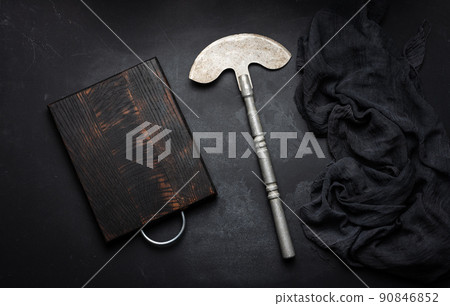Rectangular empty wooden cutting board and kitchen knife on black table with gauze napkin, top view 90846852