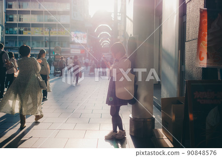 Schoolgirl in uniform with a guitar and smartphone and the city Schoolgirl in uniform with a guitar and smartphone and the city 90848576