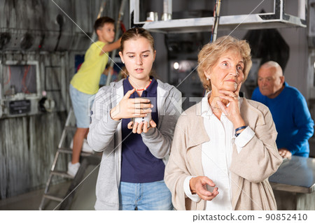 Grandchildren and grandparents in escape room Grandchildren and grandparents in escape room 90852410