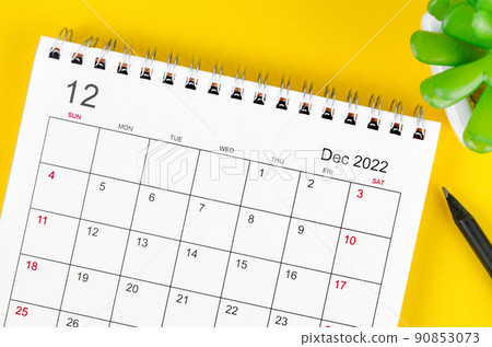 December 2022 desk calendar on yellow background. 90853073
