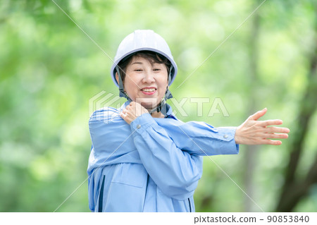 Women in work clothes, fresh green helmet, stretch Women in work clothes, fresh green helmet, stretch 90853840