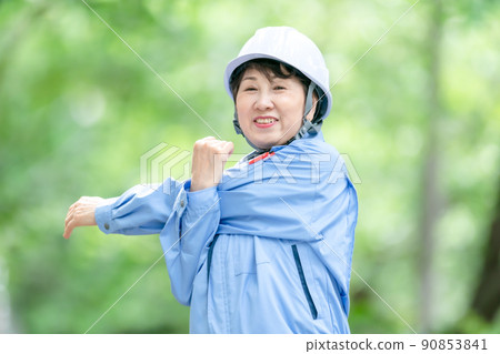 Women in work clothes, fresh green helmet, stretch Women in work clothes, fresh green helmet, stretch 90853841
