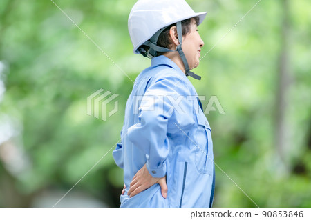 Women in work clothes, fresh green helmet, stretch Women in work clothes, fresh green helmet, stretch 90853846