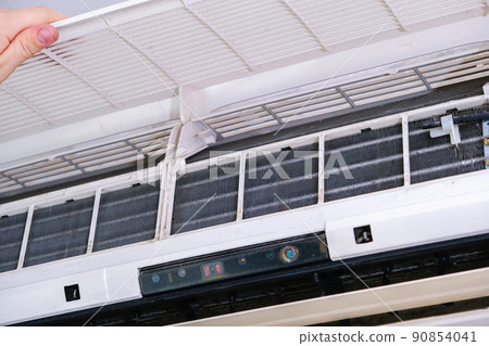 A man disassembles air conditioner for cleaning 90854041