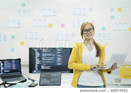 Young programmer or IT specialist satisfied with her work done. 90854491