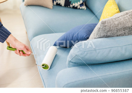 Men's hands using an adhesive carpet cleaner Men's hands using an adhesive carpet cleaner 90855387