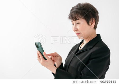 Women in mourning dress smartphone funeral 90855443