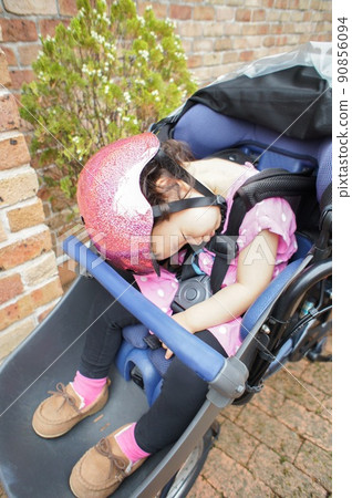 Girl sleeping in a bicycle child seat Girl sleeping in a bicycle child seat 90856094