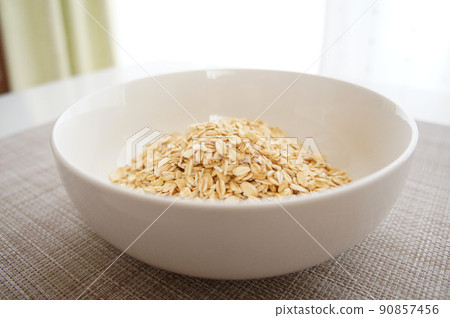 Granular oatmeal [rolled oats, traditional oats] _08 served in a white bowl 90857456