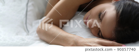 Young woman sleeping in white comfortable bed Young woman sleeping in white comfortable bed 90857740