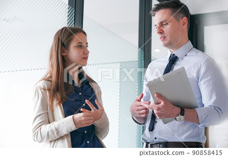Business people in the workplace are discussing a working strategy for doing business Business people in the workplace are discussing a working strategy for doing business 90858415