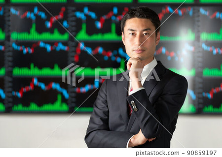 A business person who stands in front of the chart screen and looks at him A business person who stands in front of the chart screen and looks at him 90859197