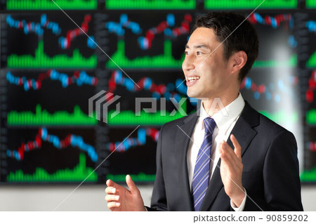 Business person having a conversation in front of the chart screen 90859202