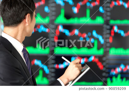 Rear view of a business person staring at the chart screen Rear view of a business person staring at the chart screen 90859209