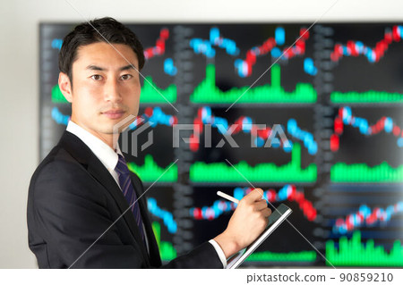 Image of a business person securities analyst trader looking in front of the chart screen Image of a business person securities analyst trader looking in front of the chart screen 90859210