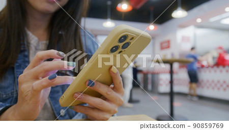 Woman use of mobile phone at outdoor 90859769
