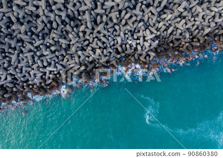 Top down view of the wave breaker over the sea Top down view of the wave breaker over the sea 90860380
