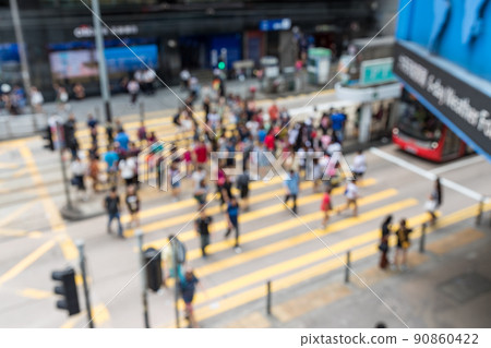 Blur of people cross the road 90860422