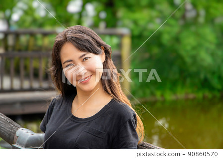 A smiling woman against the backdrop of a moat A smiling woman against the backdrop of a moat 90860570