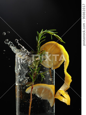 Gin tonic cocktail with lemon and rosemary. 90861017